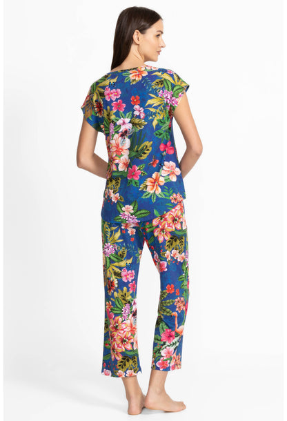 Woman wearing a colorful floral pajama  on a white background