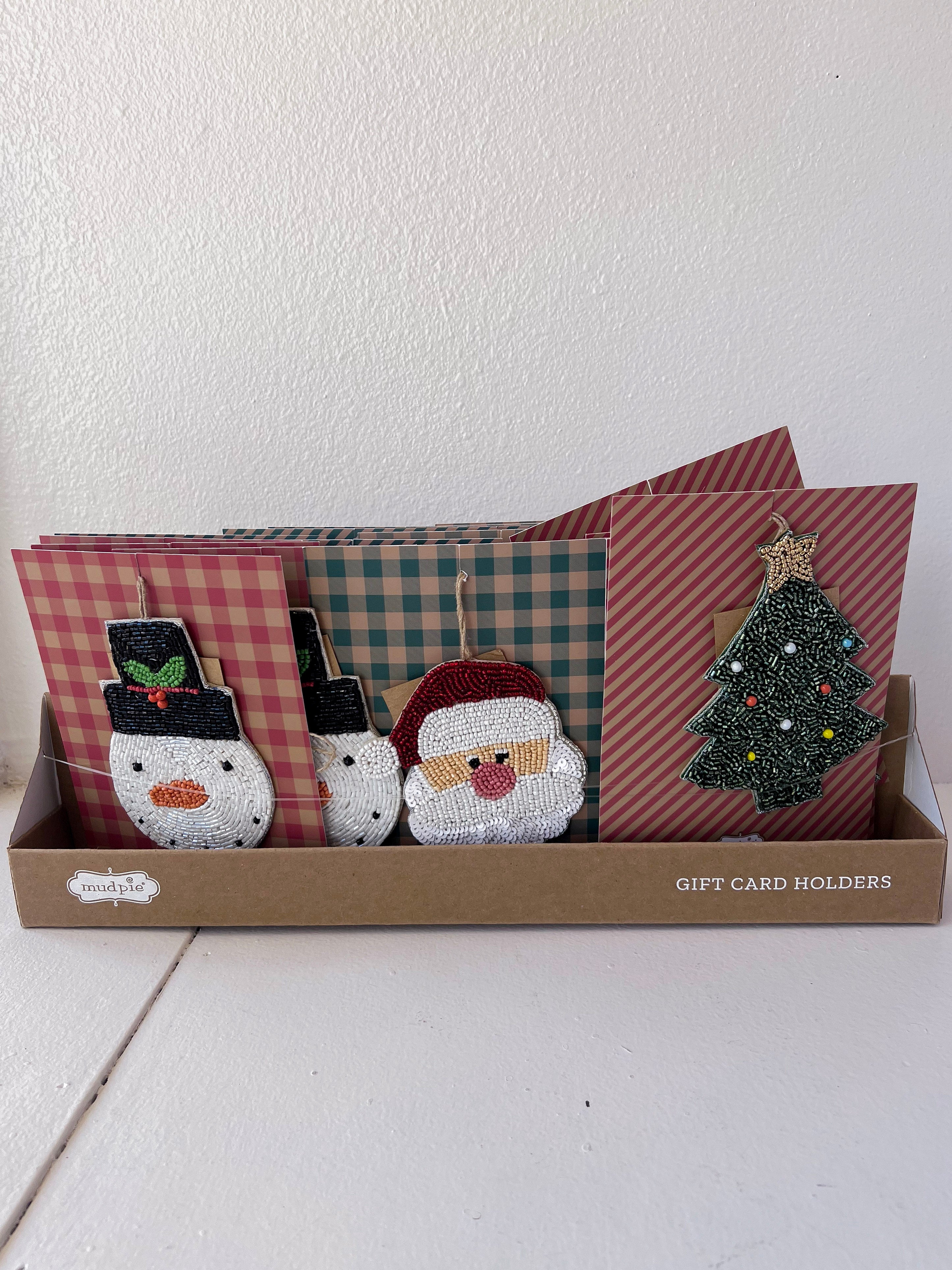 Set of gift card holders with decorative designs in a box on a white surface.