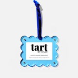 Blue decorative ornament with 'tart by Taylor' branding on a white background