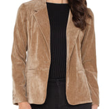 Woman wearing a brown corduroy blazer over a black top on a white background