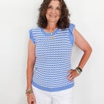 Woman wearing a blue and white striped sleeveless top against a white background