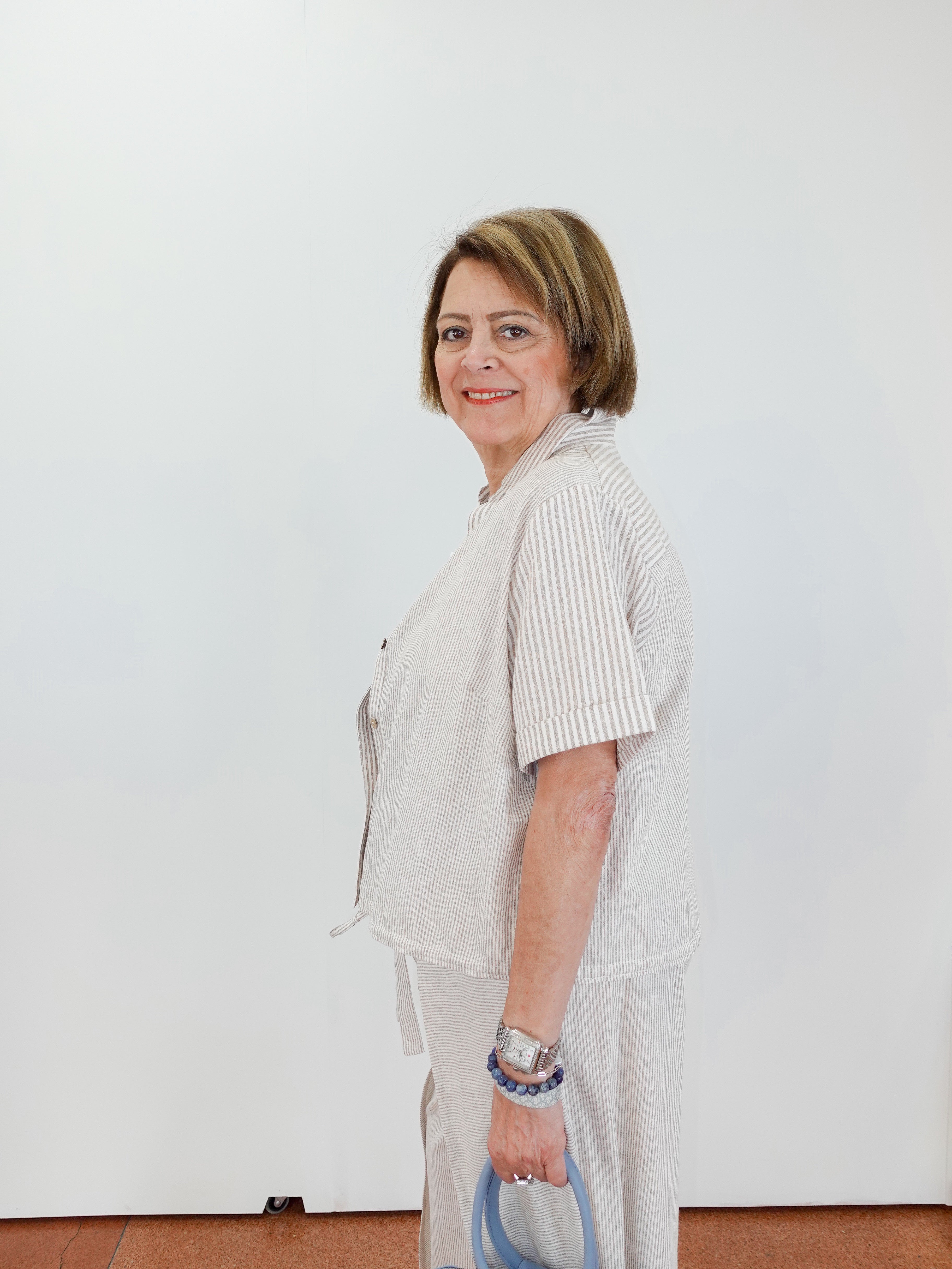 Woman wearing a light-colored outfit with a white background