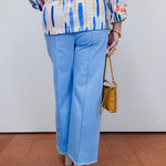 Woman wearing the Olivia wide ankle pant in pale blue with a relaxed, wide-leg fit.
