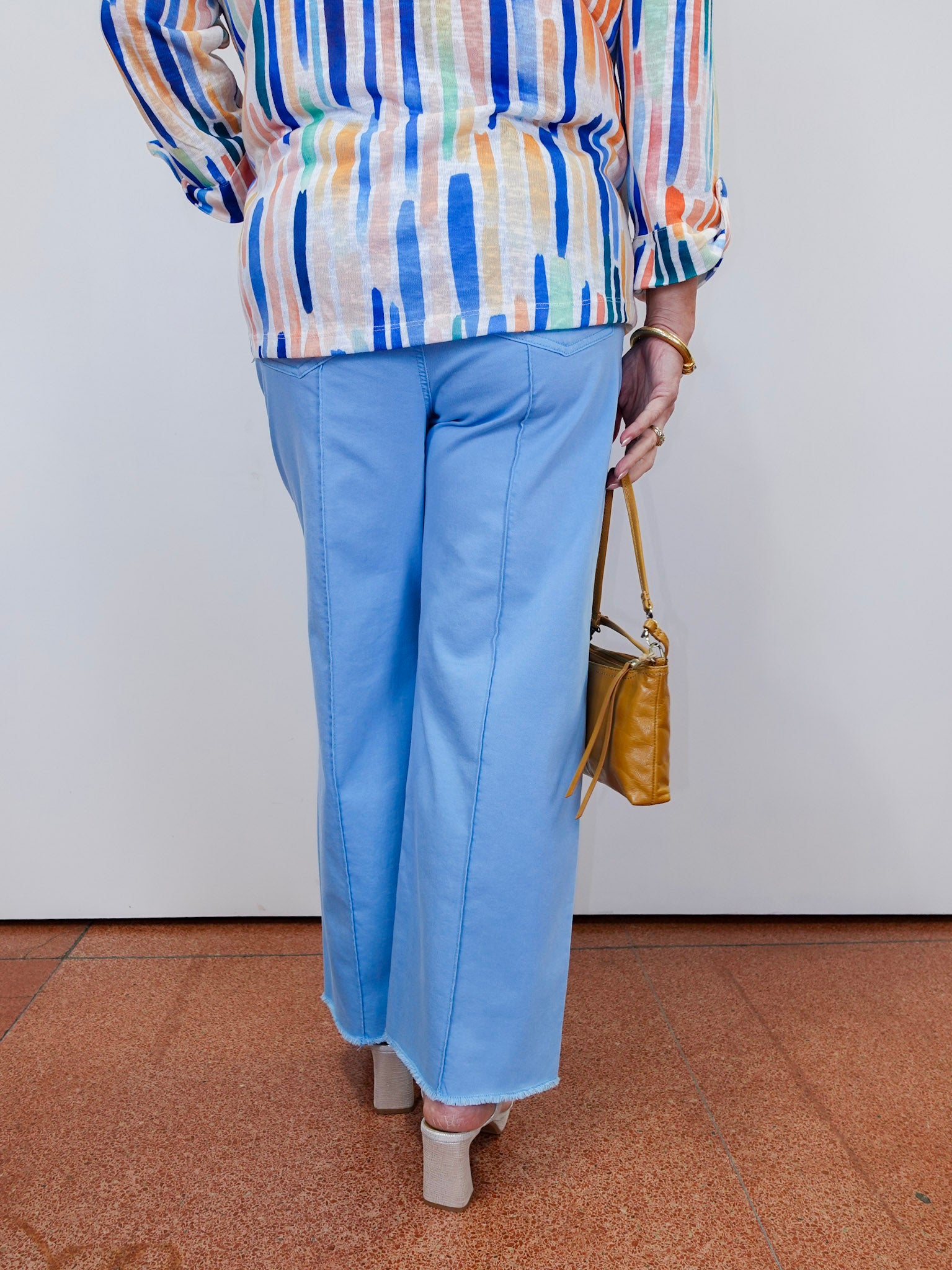 Woman wearing the Olivia wide ankle pant in pale blue with a relaxed, wide-leg fit.
