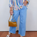Woman wearing the Olivia wide ankle pant in pale blue with a relaxed, wide-leg fit.