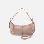 Pink handbag with decorative stitching on a white background