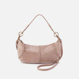Pink handbag with decorative stitching on a white background