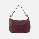 Maroon handbag with gold accents on a white background