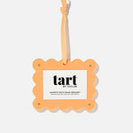 Orange photo frame ornament with 'tart by taylor' branding on a white background