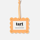 Orange photo frame ornament with 'tart by taylor' branding on a white background