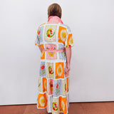 Person wearing a colorful dress with patterned design on a white background