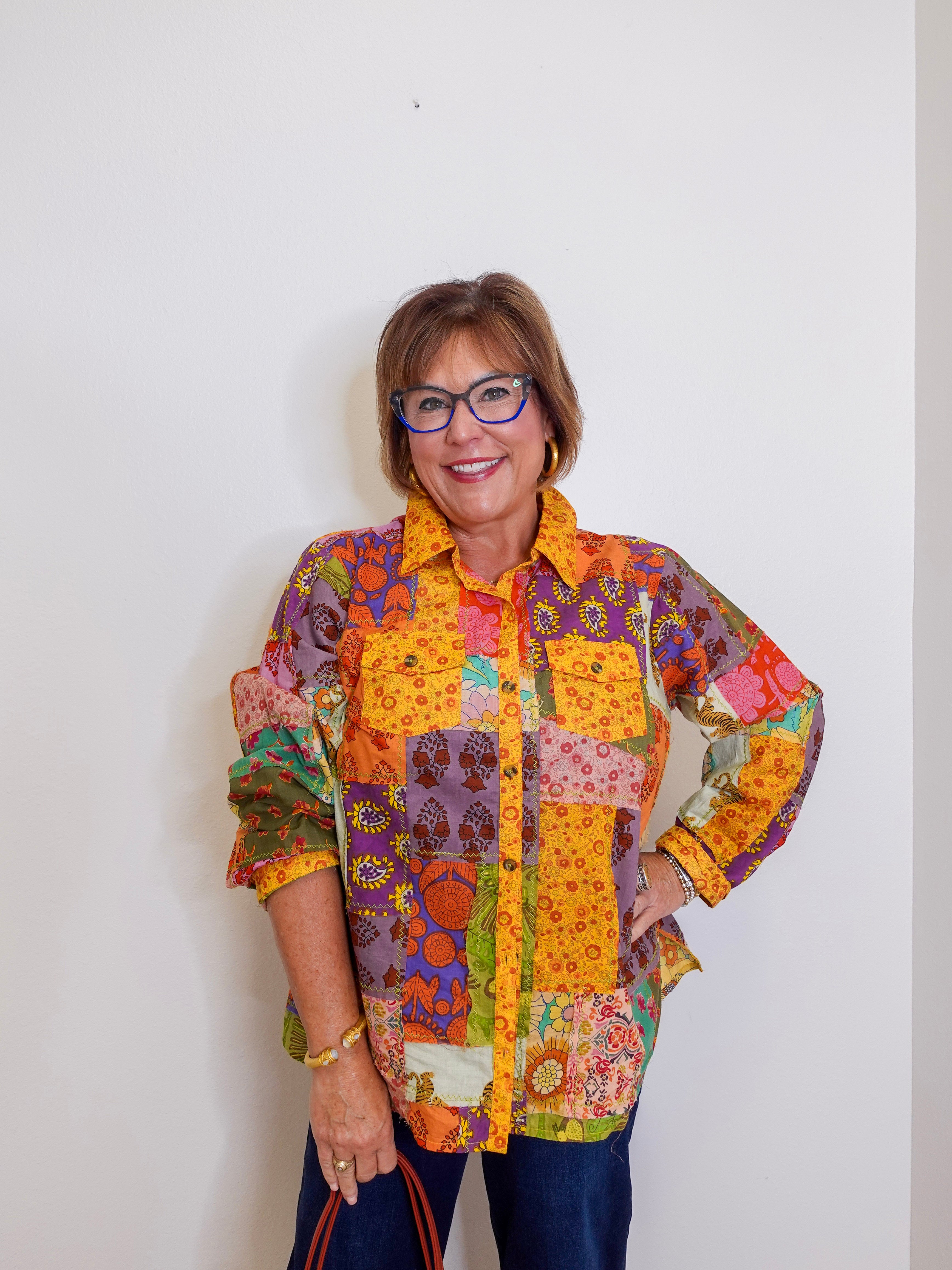 Woman wearing Ivy Jane patchwork top in multi-colored pattern
