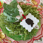 Decorative wreath with silhouette on a patterned tablecloth