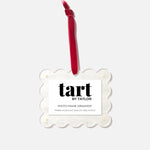 Decorative photo frame ornament with red candle on a white background, branded 'tart by Taylor'.