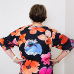 Person wearing a floral dress with a white background