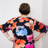 Person wearing a floral dress with a white background