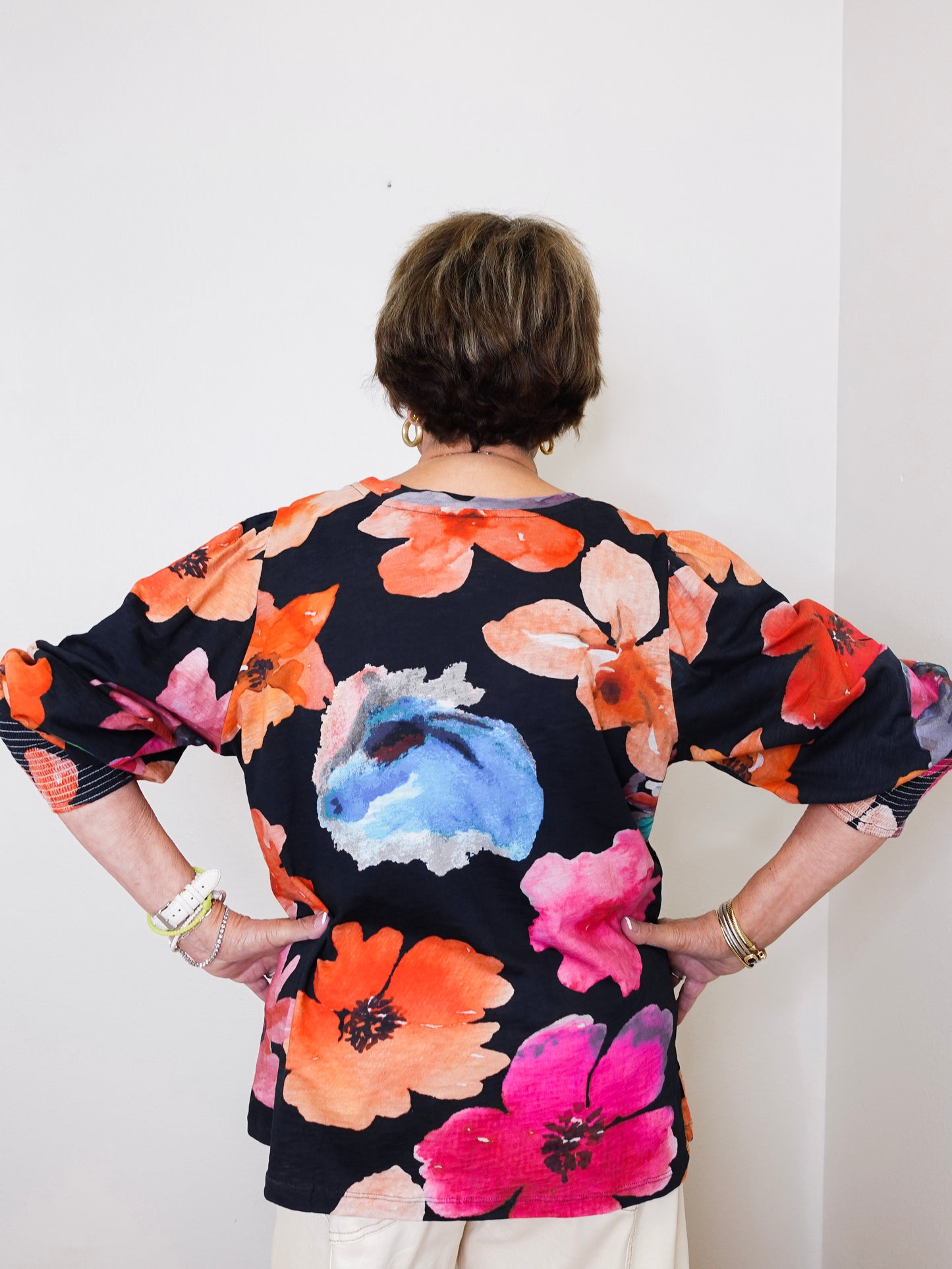 Person wearing a floral dress with a white background