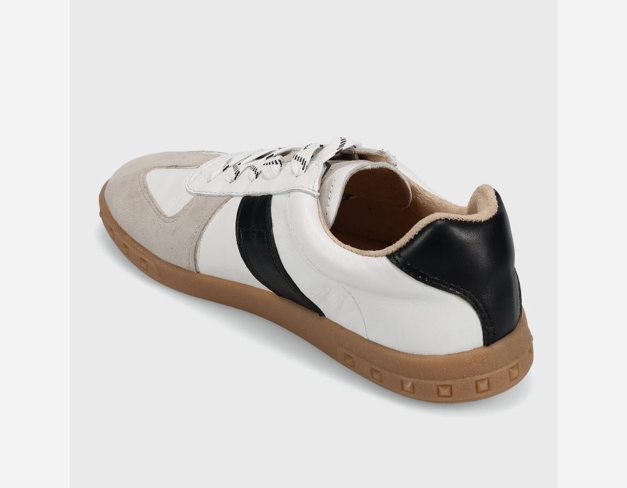 Sneaker with white, black, and brown color scheme on a light gray background