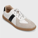 White and beige sneaker with a black stripe on a light gray background
