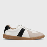 White sneaker with black and beige accents on a light gray background