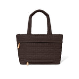 Brown quilted handbag on a white background