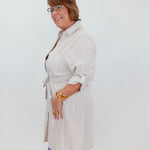 Woman wearing a striped dress with a white background