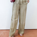 Person wearing a beige striped suit with a white background