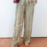 Person wearing a beige striped suit with a white background