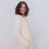 Woman wearing a white outfit against a plain background