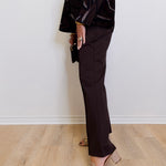 woman wearing the brown Ponte kick flare pant against a white background. 