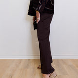 woman wearing the brown Ponte kick flare pant against a white background. 