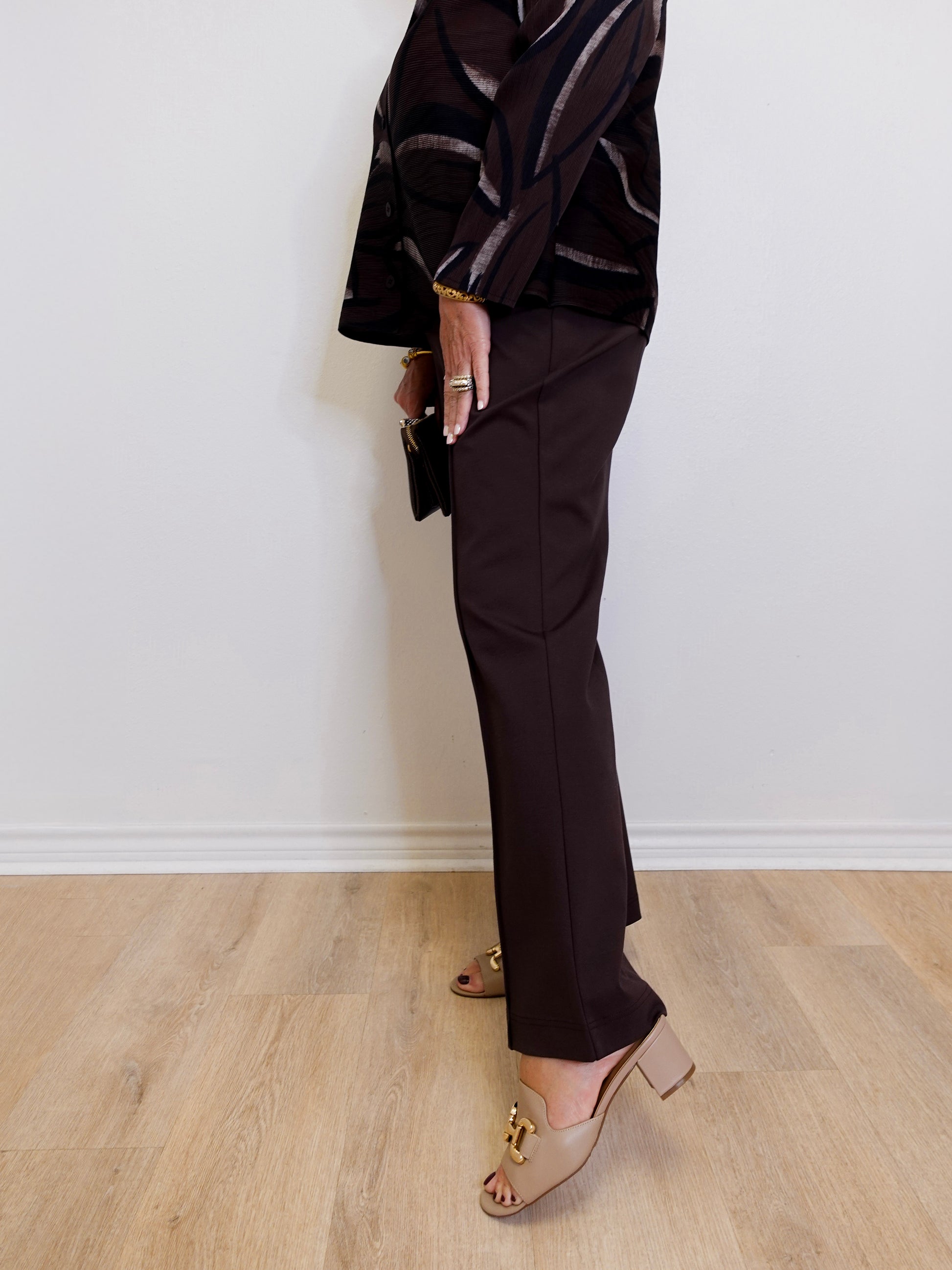 woman wearing the brown Ponte kick flare pant against a white background. 
