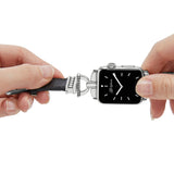 Smartwatch with black strap being adjusted by a hand on a white background