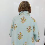 Light blue floral patterned jacket worn by a person on a white background