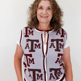 Woman wearing a sleeveless cardigan with 'ATM' pattern on a white background