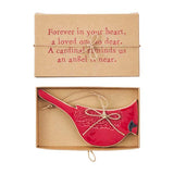 Red cardinal ornament in a cardboard box with a sentimental message.
