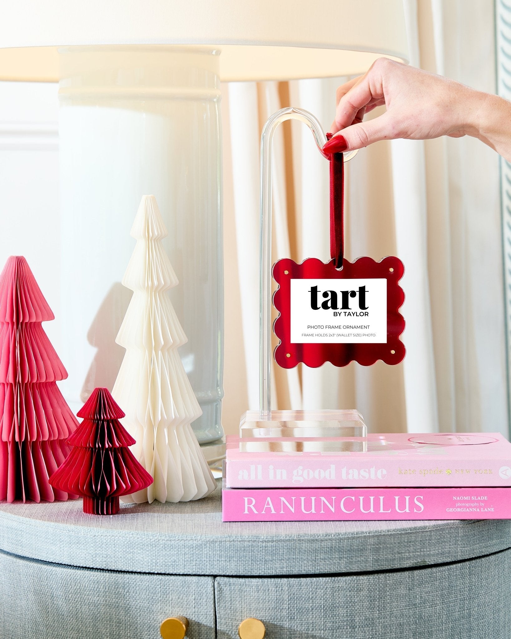 Decorative book with a 'tart' label, surrounded by pink and white paper trees on a table.