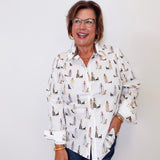 Woman wearing a white shirt with dog pattern against a white background