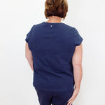 Person wearing a navy blue outfit on a white background