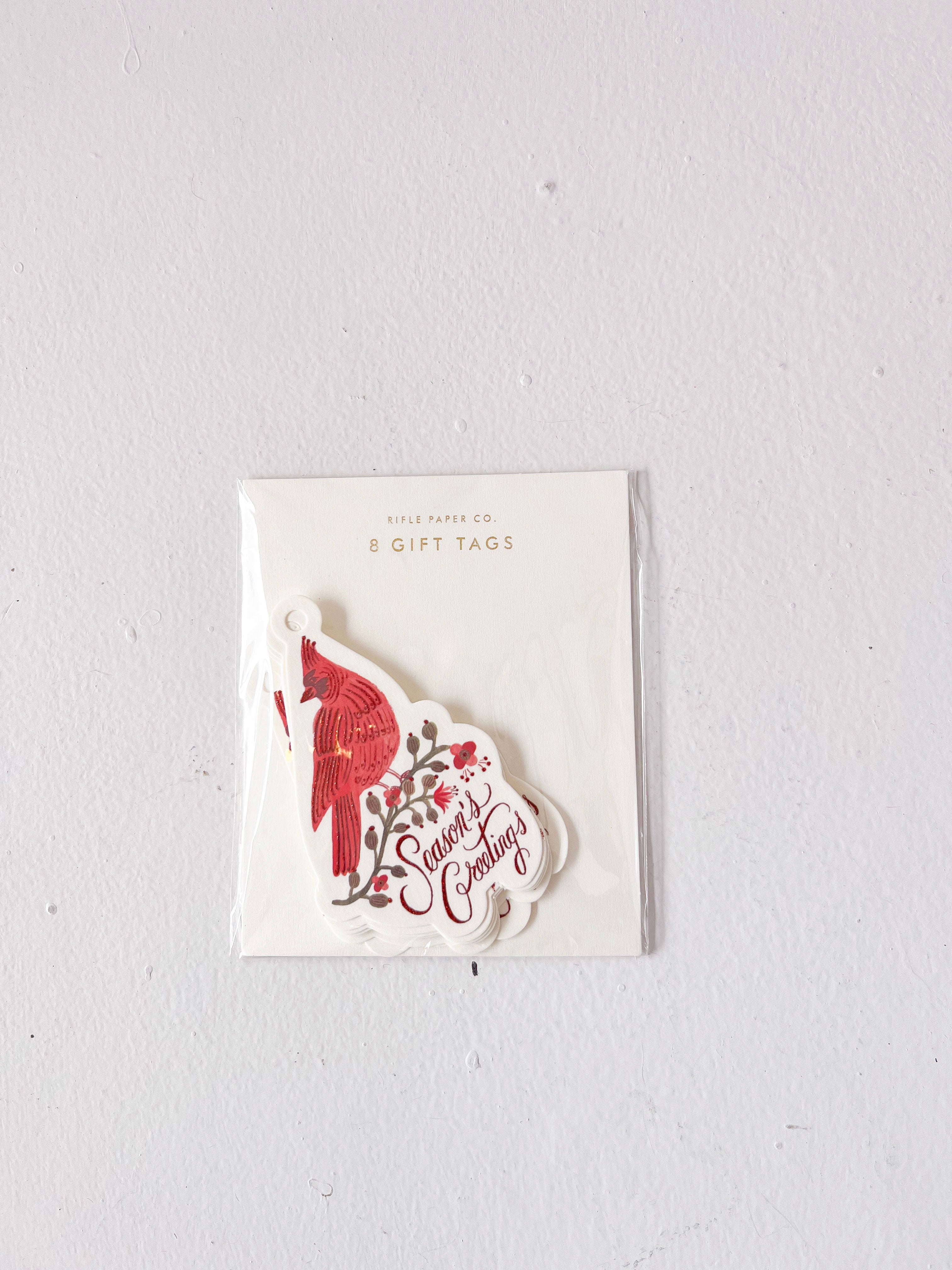 Pack of gift tags with a red and white design on a light gray background