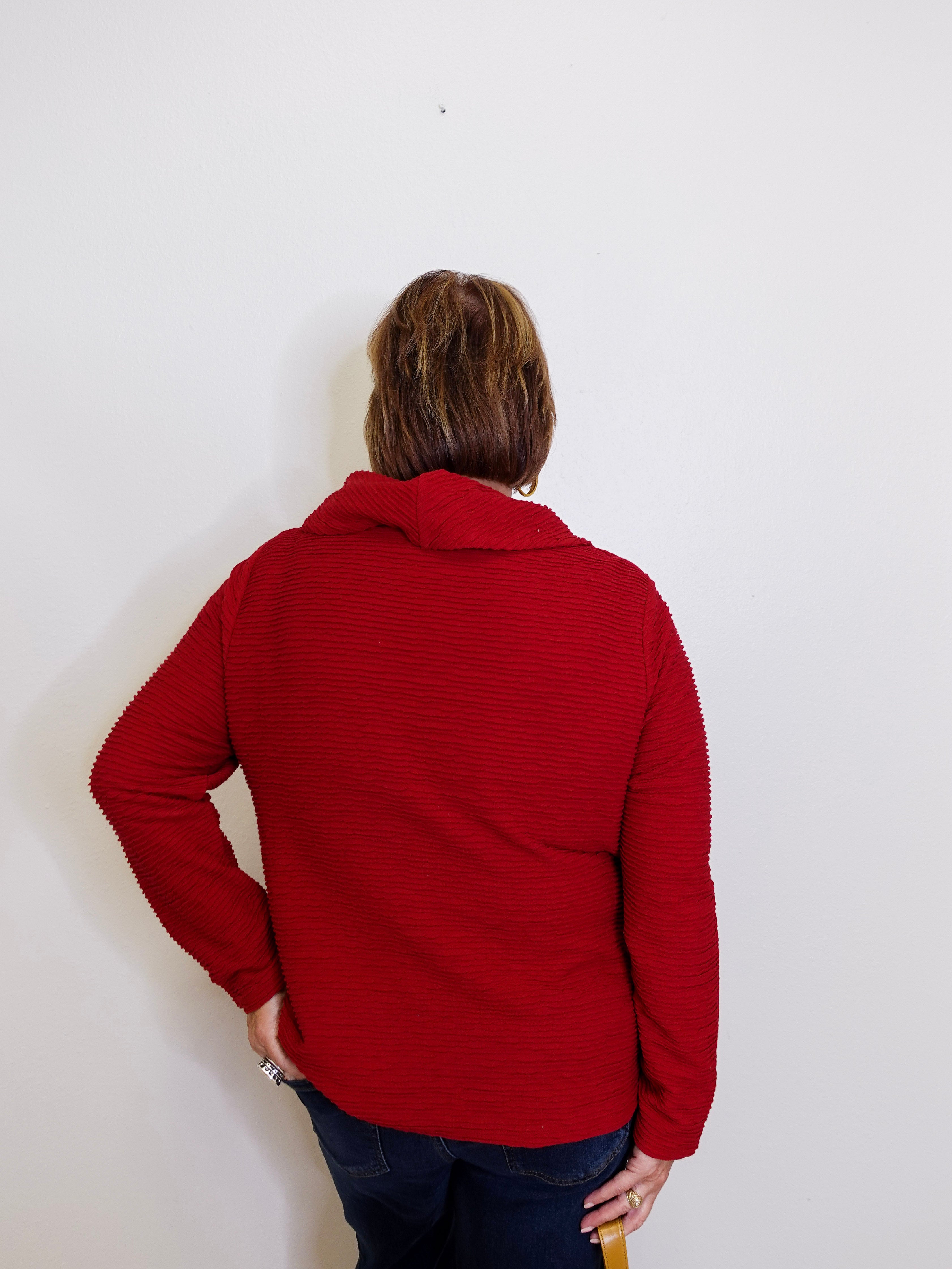 Person wearing a red jacket against a white background
