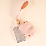 Pink pouch with a gold chain and rhinestone pouch on a beige background