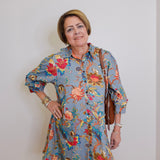 Woman wearing a floral dress with a plain background