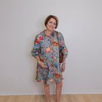 Woman wearing a floral dress with a plain background