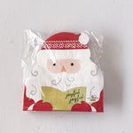 Packaged napkins with a Santa Claus design on a white background