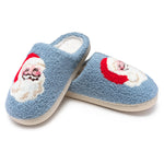 Pair of blue slippers with Santa Claus design on a white background
