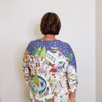 Person wearing a colorful patterned shirt with a white background