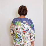 Person wearing a colorful patterned shirt with a white background