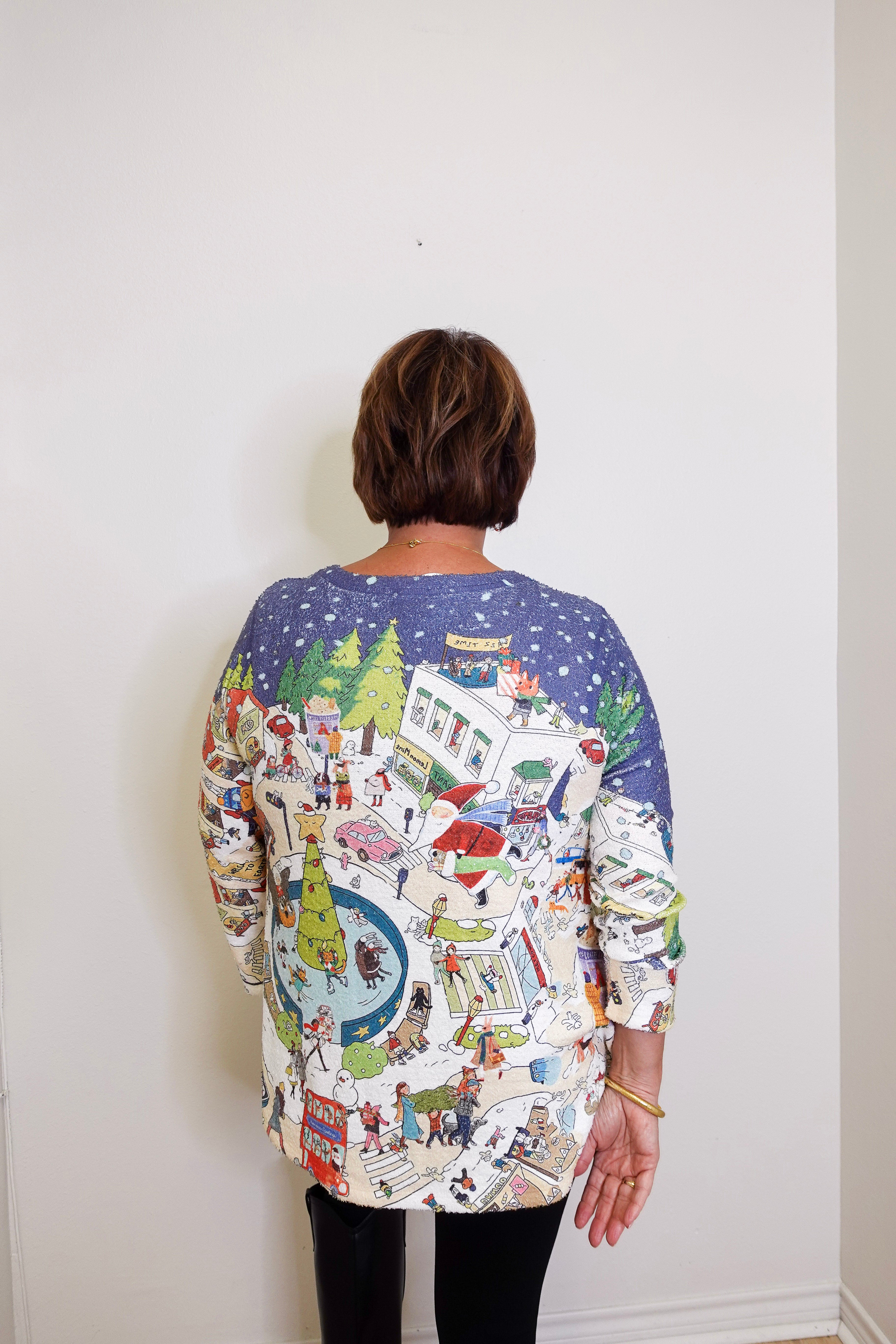 Person wearing a colorful patterned shirt with a white background