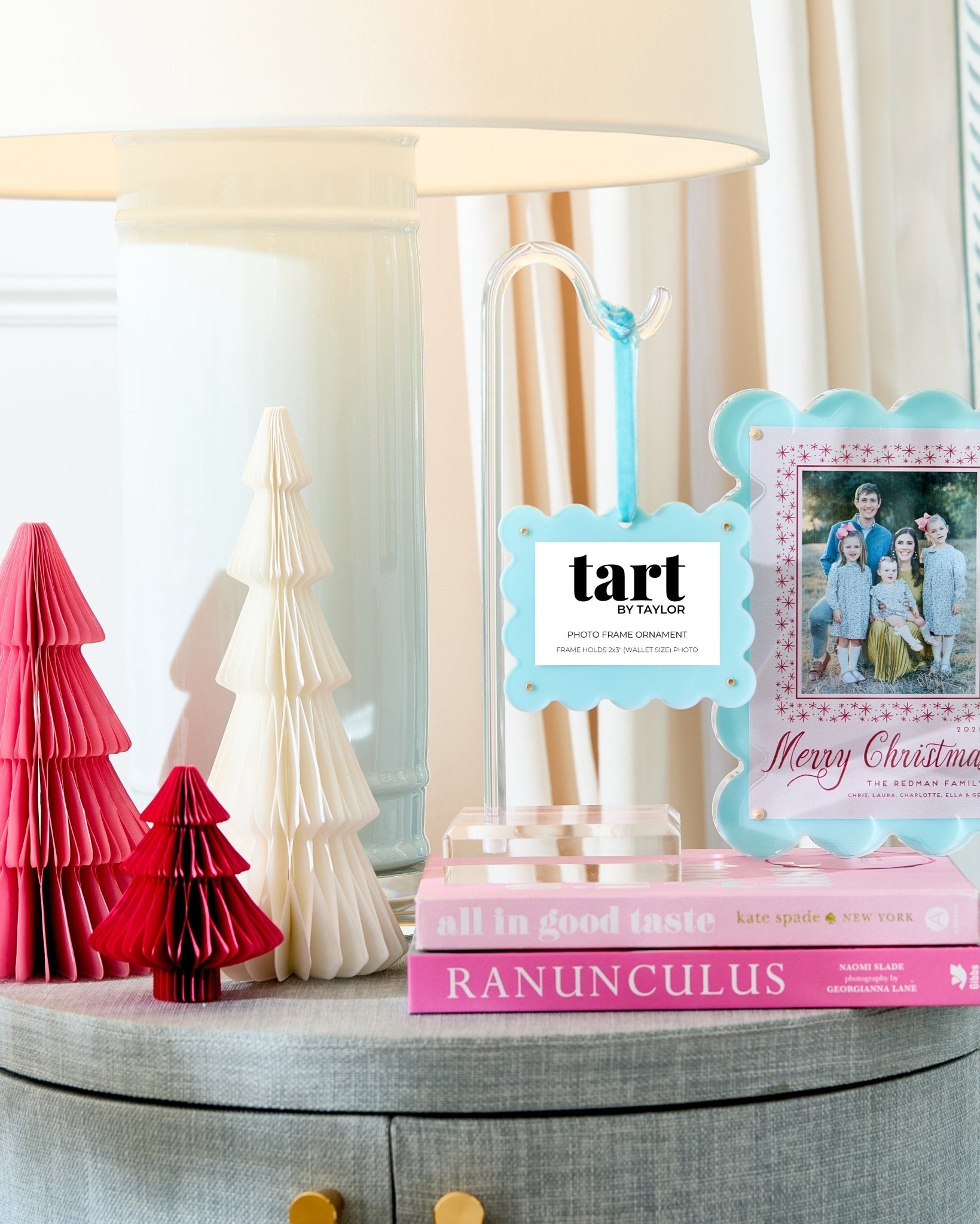 Decorative items including a lamp, books, and a photo frame with 'tart' branding on a table.